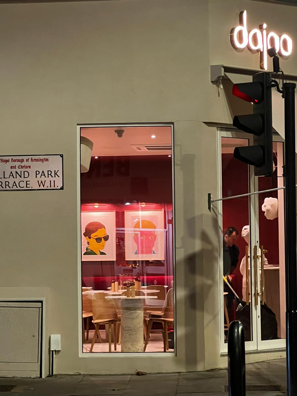 Dajoo night corner with the illuminated sign, Holland Park Terrace W11 street sign and interior glimpse of Iranian portrait art