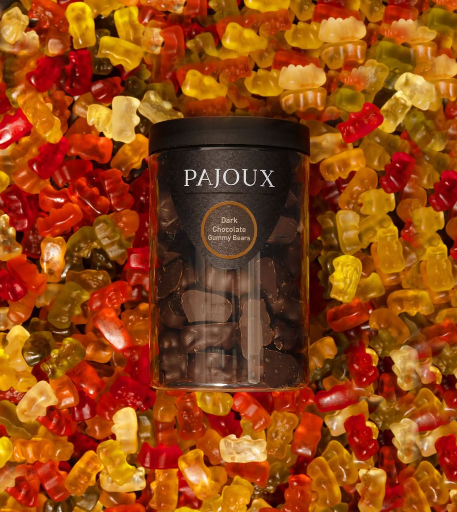 Dark Chocolate Gummy Bears jar floating on a sea of multi-coloured gummy bears — art-directed campaign image