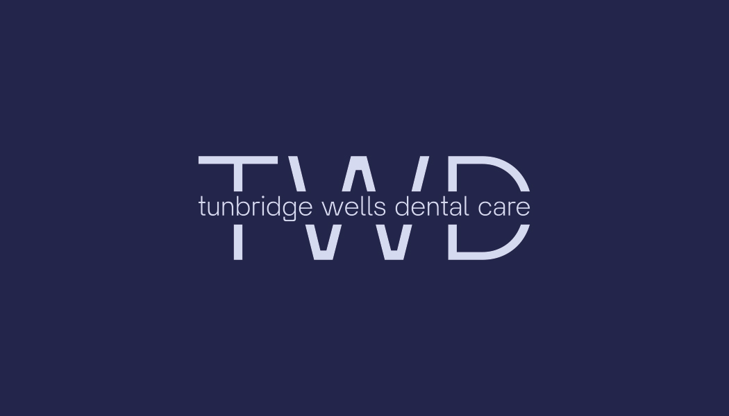 Tunbridge Wells Dental Care primary logo — a thin light-periwinkle TWD monogram in large uppercase with 'tunbridge wells dental care' set lowercase across the middle, on a deep navy field